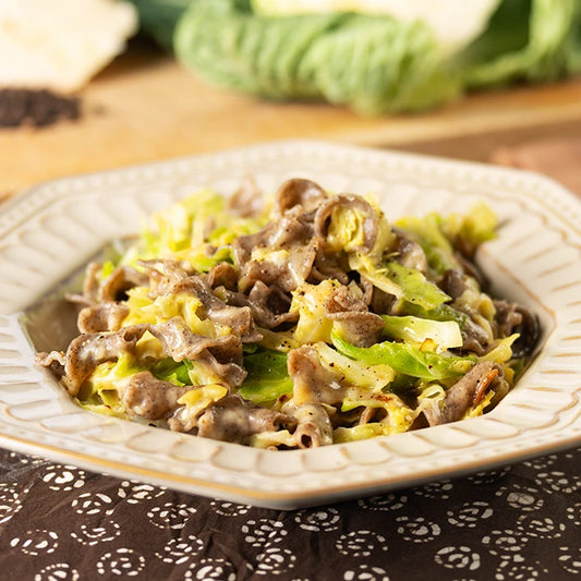 Piatto con LEGÙ Gigli ÙNICA - Sorgo, Fagioli neri e Saraceno conditi con cavolo e salsa, una pasta di legumi senza glutine e ricca di proteine vegetali.